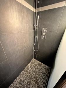 bagno con doccia e pavimento piastrellato di Karukera By du fort a Le Gosier