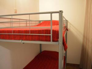 een paar stapelbedden met rode lakens erop bij Appartement Argelès-sur-Mer, 1 pièce, 4 personnes - FR-1-225-100 in Argelès-sur-Mer