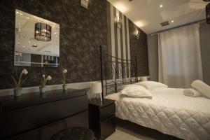 Ένα ή περισσότερα κρεβάτια σε δωμάτιο στο APOLLONIO Suites