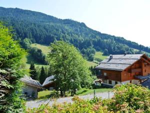 a wooden house in the middle of a mountain at Appartement Le Grand-Bornand, 2 pièces, 4 personnes - FR-1-241-91 in Le Grand-Bornand