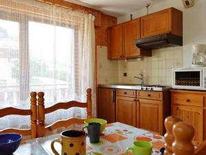 a kitchen with a table with a table cloth on it at Appartement Le Grand-Bornand, 1 pièce, 5 personnes - FR-1-241-45 in Le Grand-Bornand