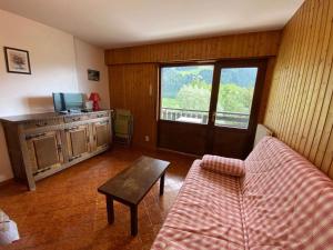 a living room with a couch and a table at Appartement Le Grand-Bornand, 1 pièce, 4 personnes - FR-1-241-75 in Le Grand-Bornand