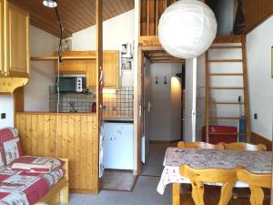 a kitchen and a dining room with a table and a room at Appartement Le Grand-Bornand, 2 pièces, 5 personnes - FR-1-241-85 in Le Grand-Bornand