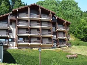 a large building with wooden balconies and a street light at Appartement Le Grand-Bornand, 1 pièce, 4 personnes - FR-1-241-98 in Le Grand-Bornand