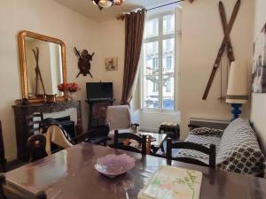 a living room with a table and chairs at Appartement Cauterets, 3 pièces, 6 personnes - FR-1-234-109 in Cauterets