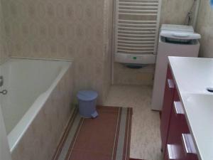 a bathroom with a tub and a toilet and a sink at Appartement Cauterets, 3 pièces, 6 personnes - FR-1-234-109 in Cauterets