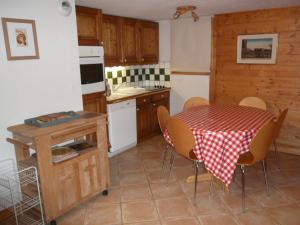a kitchen with a table and a table and chairs at Appartement Méribel, 3 pièces, 6 personnes - FR-1-411-160 in Les Allues
