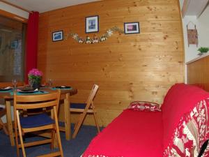 a room with a table and a bed and a table and chairs at Studio Valmorel, 2 pièces, 4 personnes - FR-1-291-772 in Valmorel