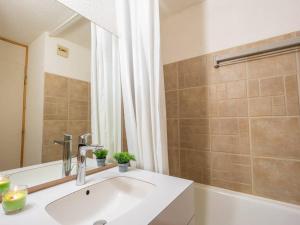 a bathroom with a sink and a tub and a mirror at Appartement Valmorel, 1 pièce, 4 personnes - FR-1-291-769 in Valmorel