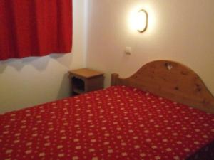Les EstarisにあるAppartement Orcières Merlette, 3 pièces, 6 personnes - FR-1-262-118の赤いベッド1台(赤い毛布付)が備わるベッドルーム1室が備わります。