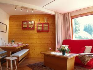 sala de estar con sofá rojo y mesa en Appartement Valmorel, 3 pièces, 8 personnes - FR-1-291-759, en Valmorel