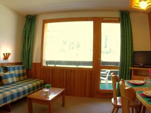 a living room with a couch and a window at Appartement 2 pièces à Valmorel pour 6 pers, balcon, animaux acceptés - FR-1-291-764 in Valmorel