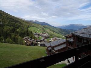 a view from a balcony of a village in the mountains at Studio Valmorel, 1 pièce, 2 personnes - FR-1-291-768 in Valmorel