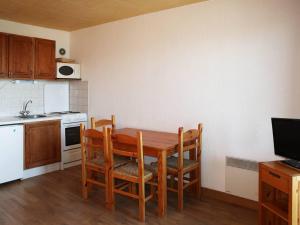 a small kitchen with a wooden table and chairs at Studio Les Orres, 1 pièce, 4 personnes - FR-1-322-5 in Les Orres