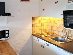 een keuken met een wastafel en een magnetron bij Studio Les Orres, 1 pièce, 4 personnes - FR-1-322-21 in Les Orres