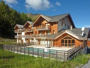 a large house with a pool in front of it at Appartement Les Orres, 2 pièces, 4 personnes - FR-1-322-69 in Les Orres