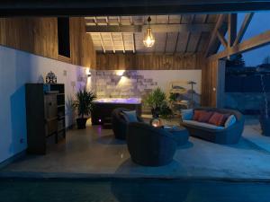 a living room with couches and a table at La Chambre Enchantée in La Baffe