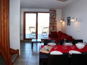 ein Wohnzimmer mit einem Tisch und einem roten Sofa in der Unterkunft Chalet Les Orres, 3 pièces, 6 personnes - FR-1-322-149 in Les Orres