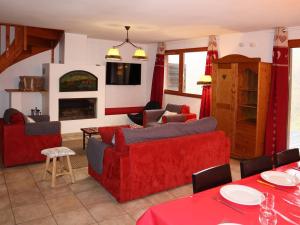 a living room with red furniture and a fireplace at Chalet Les Orres, 5 pièces, 10 personnes - FR-1-322-65 in Les Orres