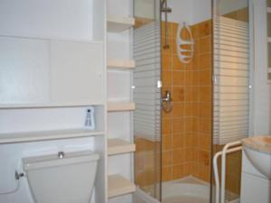 a bathroom with a toilet and a glass shower at Appartement Saint-Cyprien, 1 pièce, 4 personnes - FR-1-225D-408 in Saint-Cyprien-Plage