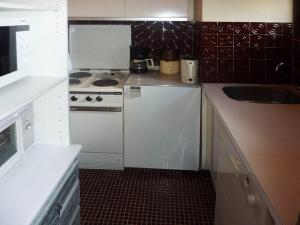 a small kitchen with a stove and a sink at Appartement Les Orres, 2 pièces, 6 personnes - FR-1-322-276 in Les Orres