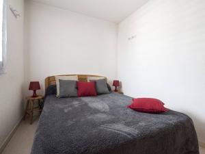 サン・ラリー・スランにあるAppartement Saint-Lary-Soulan, 2 pièces, 6 personnes - FR-1-296-216のベッドルーム1室(赤い枕2つ付きのベッド1台付)