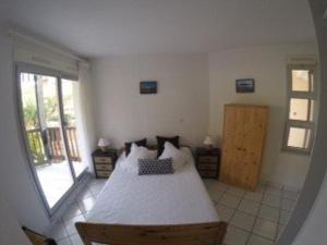 a bedroom with a bed and a large window at Appartement Vieux-Boucau-les-Bains, 2 pièces, 5 personnes - FR-1-379-18 in Vieux-Boucau-les-Bains