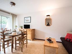 a living room with a table and a couch at Appartement Saint-Lary-Soulan, 2 pièces, 4 personnes - FR-1-296-195 in Saint-Lary-Soulan