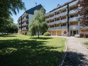 a tree in front of a building at Appartement 6 pers, 3 chambres, proche centre et pistes, parking privé, balcon, tout confort - FR-1-296-176 in Saint-Lary-Soulan
