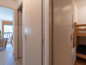 a white door in a room with a table at Studio Saint-Lary-Soulan, 1 pièce, 4 personnes - FR-1-296-205 in Saint-Lary-Soulan