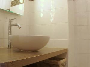 a bathroom with a bowl sink on a wooden counter at Appartement Valmorel, 3 pièces, 6 personnes - FR-1-291-803 in Valmorel