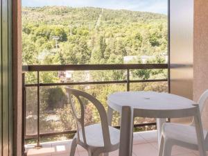 a white table and chairs on a balcony with a view at Appartement Briançon, 2 pièces, 6 personnes - FR-1-330C-16 in Briançon