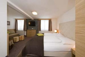a hotel room with a bed and a couch at Ferienhaus & Apart Post in See