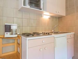 a kitchen with white cabinets and a blender at Appartement Briançon, 1 pièce, 4 personnes - FR-1-330C-41 in Briançon