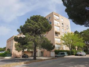 a large building with a tree in front of it at Appartement T2 en bord de mer - Terrasse - Parking - Argelès-sur-Mer - FR-1-388-31 in Argelès-sur-Mer +6 photos