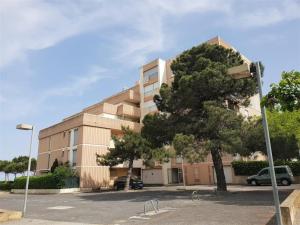 a building with a tree in front of it at Appartement T2 en bord de mer - Terrasse - Parking - Argelès-sur-Mer - FR-1-388-31 in Argelès-sur-Mer +5 photos