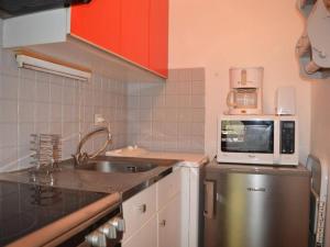 a small kitchen with a sink and a microwave at Appartement Le Grand-Bornand, 1 pièce, 4 personnes - FR-1-241-185 in Le Grand-Bornand