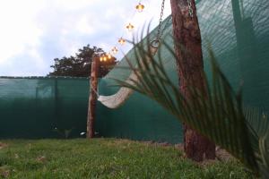 a hammock hanging from a tree next to a fence at Cabaña Alpina SEAL in Oxapampa