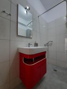 a bathroom with a red sink and a mirror at Two bedroom modern apartment in Komotini