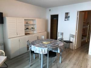 a kitchen with a table and chairs in a room at Appartement 6 pers., 1 ch. avec balcon. 100m des pistes! - FR-1-404-122 in La Mongie