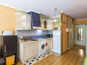 a kitchen with a washer and dryer in it at Studio cabine 4 personnes, proche des pistes à Gourette - FR-1-400-65 in Gourette