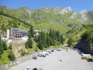 a parking lot with cars parked in front of a mountain at Studio cabine 4 personnes, proche des pistes à Gourette - FR-1-400-65 in Gourette +4 photos