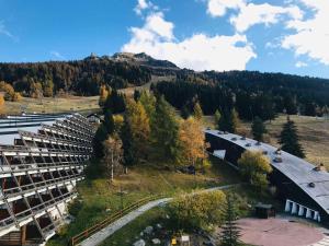 an aerial view of a building with a mountain at Studio 4 personnes Arc 1600 à 50m des pistes, balcon, TV - FR-1-411-335 in Arc 1600
