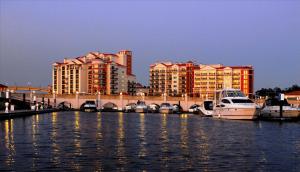 a group of boats docked in the water near buildings at Villas at Marina Inn at Grande Dunes in Myrtle Beach