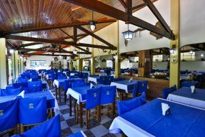 a dining room with blue tables and chairs at Hotel Fazenda Village Montana in Socorro