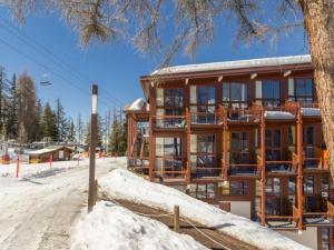 a large building with snow on the ground at Appartement Les Arcs 1800, 2 pièces, 6 personnes - FR-1-411-338 in Arc 1800