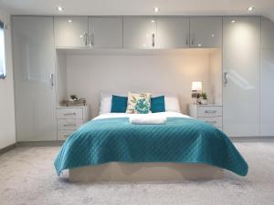 una camera da letto con un grande letto con una coperta blu di Spacious City Home with Free Parking, Fast Wi-Fi & Netflix a Coventry