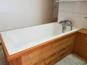 a bath tub with a faucet in a room at Studio Les Arcs 1600, 1 pièce, 3 personnes - FR-1-411-413 in Arc 1600