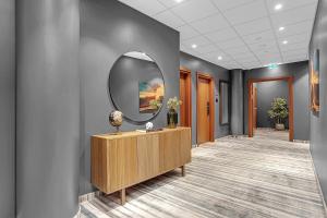a hallway of an office with a mirror on the wall at Alva Hotel in Reykjav&iacute;k