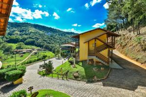 a small yellow building on the side of a hill at Hotel Fazenda Village Montana in Socorro